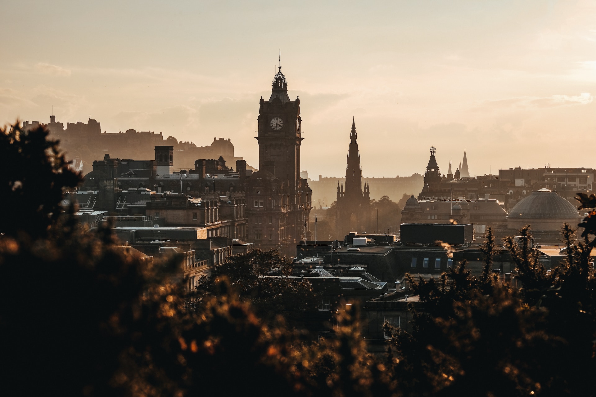 View over a historic city with a castle and clock tower in the shot