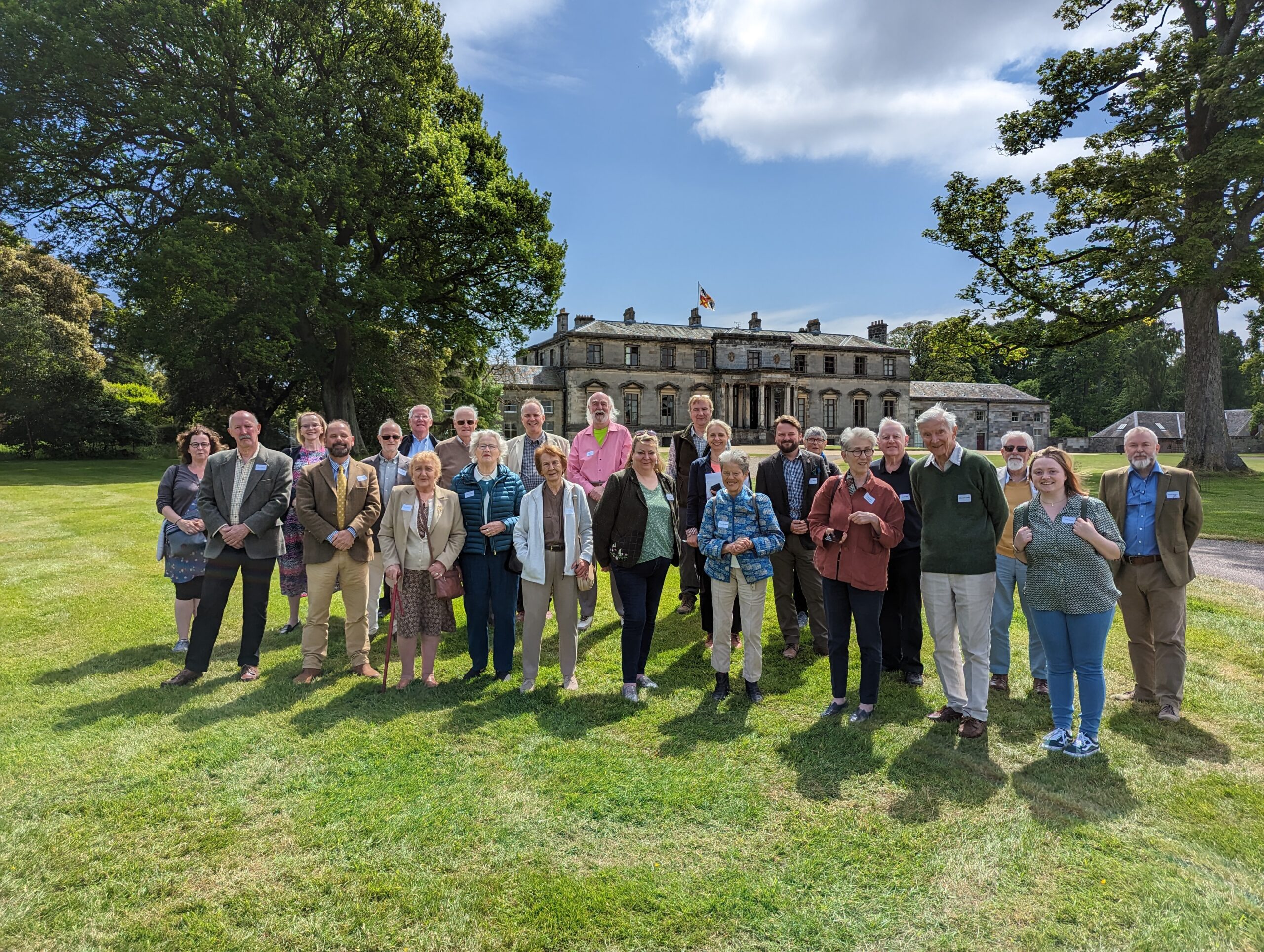 Broomhall House tour_1_Image Credit SocAntScot Group of people standing in front of a historic building smiling