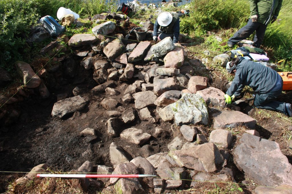 Excavations underway on the artificial islet settlement in Loch na Claise, with Historic Assynt (© AOC Archaeology Group)