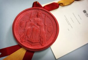 Photo of a large red wax seal showing a queen on a throne