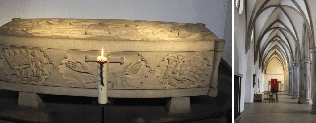 Photo a wooden coffin or tomb decorated with hands and fruits, with a burning candle stood before it, and right; the interior of the church the tomb is in