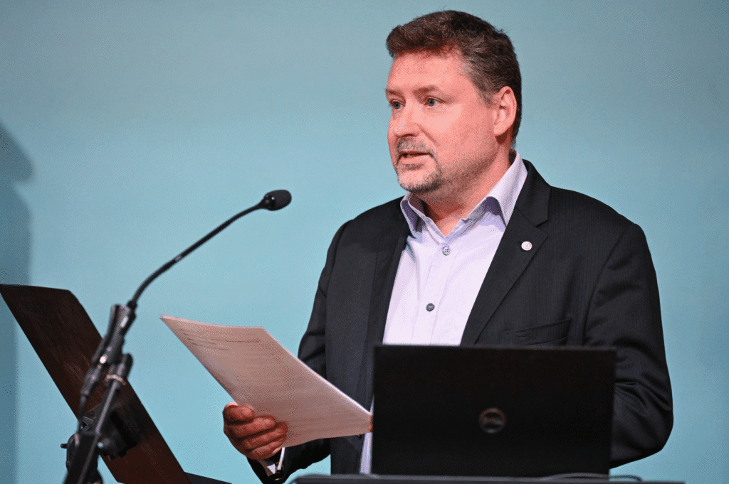 Simon Gilmour at December 2023 Lecture (Image credit: Neil Hanna) Person speaking in front of a microphone holding notes