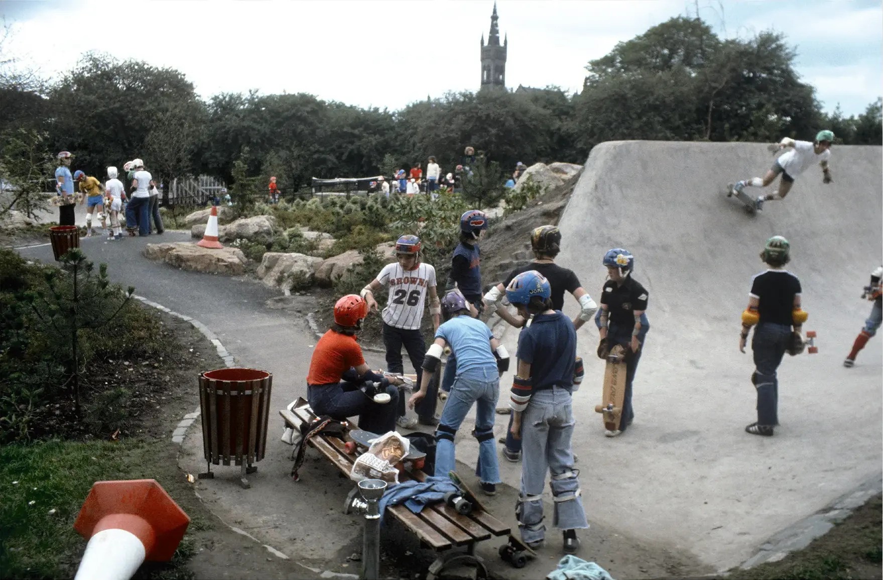 Young people in 1978 wearing helmets and other safety gear skateboarding at Kelvin Wheelies skatepark