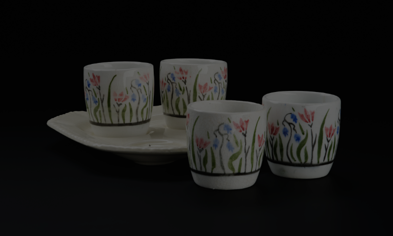 Photo of four small white egg cups with hand-painted flowers
